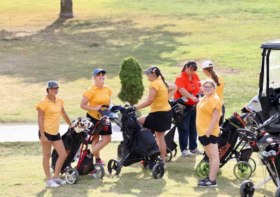 The Lady Indians golf team  gets ready for their tournament.